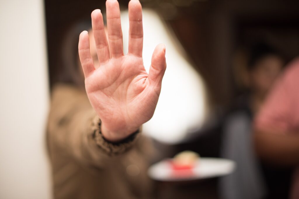 A hand rejecting an offer, symbolizing customer churn.